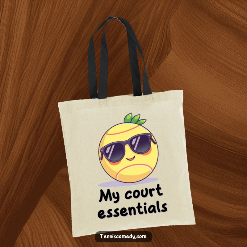 Funny tote bag showcasing a tennis ball in sunglasses, relaxing on a court, designed for humor and practicality as a gift.
